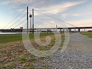 The Rheinknie bridge and the Rheinturm tower in the city of Dusseldorf. View of the city skyline from the bank of the river Rhine photo