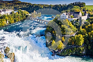 Rhine Falls or Rheinfall, Switzerland panoramic aerial view. Tourist boat in waterfall. Bridge and border between the cantons photo