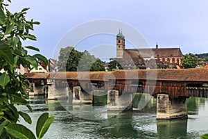 The Rhine with the historic wood bridge and Fridolins minster in Bad Saeckingen
