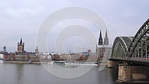 Rhine river in Cologne Germany with freight ship. Hohenzollern Bridge and Cologne Cathedral