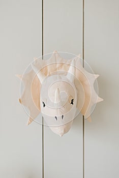 Rhinoceros or dinosaur on the wall. Stylish Scandinavian children`s room with a decorated wooden wall