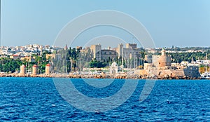 Rhodes cityscape with Mandraki harbor, Rhodes fortress, fort of St. Nicholas, windmills and New market Nea Agora