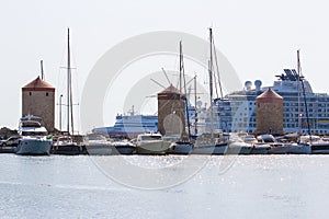 Rhodes island landmark, Mandraki Port, Greece. many luxury white large yacht at anchor