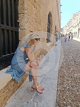 Woman sitting at the old town stone photo