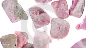 Rhodochrosite heap jewel stones texture on white light background. Moving right seamless loop backdrop