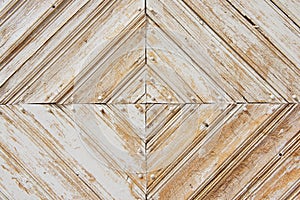 Rhomb pattern of the old weathered white-painted wooden gate. photo