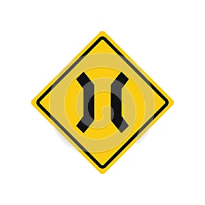 Rhomboid traffic signal in yellow and black, isolated on white background. Warning of road narrowing photo