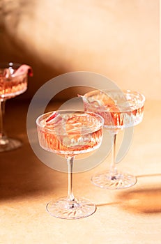 Rhubarb gin and tonic cocktail, front view of glasses with alcohol cocktail