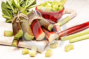 Rhubarb stalks on a board, white background. Long banner format