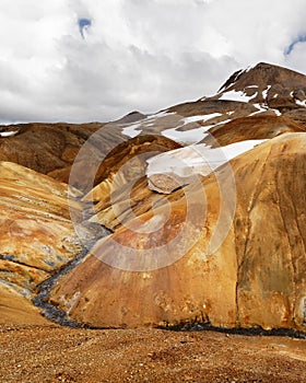 Rhyolite mountains in Iceland with snowfields photo