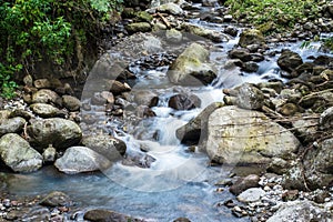 The Rhythm of Nature: Slow Shutter Speed Shots of Water and Rocks in Motion