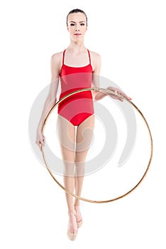 Rhythmic gymnast training holding hoop in hands