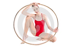 Rhythmic gymnast training holding hoop and looking at camera isolated on white