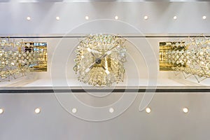 Rhythmic texture on suspended ceiling with rows of halogen spots lamps and drywall construction with chandelier. Stretch ceiling