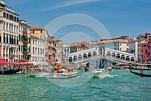 Rialto bridge with boats and gondolas. Grand Canal, Venice, Italy