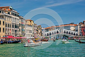 Rialto bridge with boats and gondolas. Grand Canal, Venice, Italy