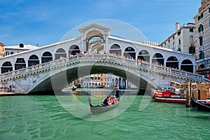 Rialto bridge with boats and gondolas. Grand Canal, Venice, Italy