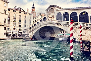 Rialto bridge with gondola on Grand Canal in Venice, Italy.