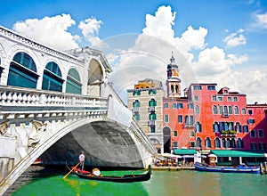 Rialto Bridge with Gondola under the bridge in Venice, Italy