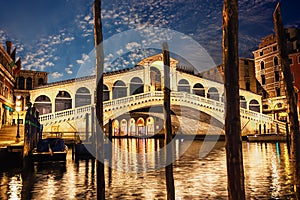 The Rialto bridge, night view from the wharf of gondolas