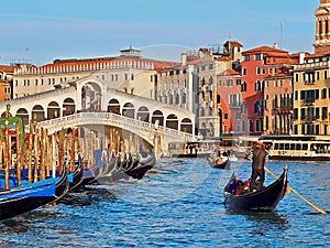 Cityscape of Venice with Rialto bridge and a gondola in front