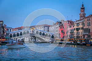 Rialto and ornate Gondolas in Grand Canal pier at sunset, Venice, Italy