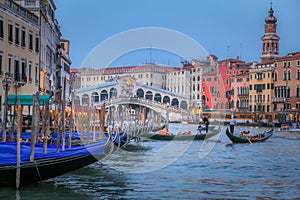 Rialto and ornate Gondolas in Grand Canal pier at sunset, Venice, Italy