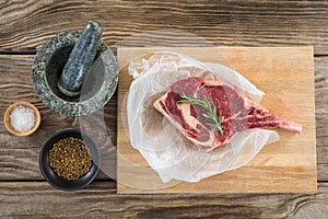 Rib chop, rosemary herb, salt, corainder seeds and stone grinder