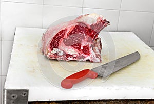 Rib eye piece of meat on cutting board