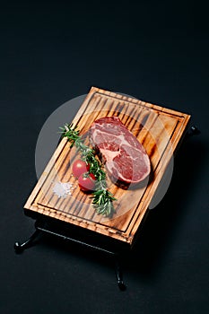 Rib eye steak on a black background.