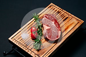 Rib eye steak on a black background.