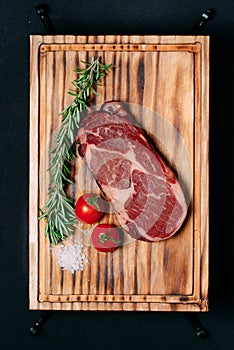 Rib eye steak on a black background.