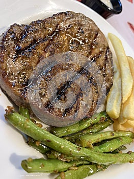 Rib Eye Steak with french fries and stir fried green beans
