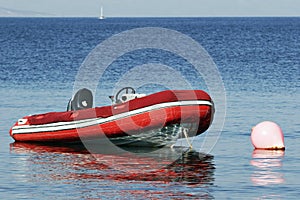 RIB, rigid inflatable boat moored at buoy