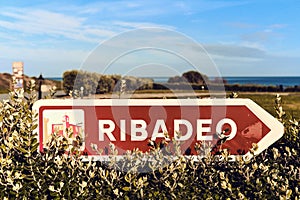 Ribadeo sign post against blue sky. Northern of Spain photo