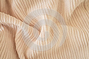 Ribbed beige corduroy or velvet texture background