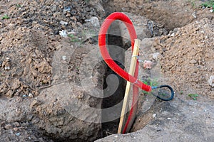 Ribbed red plastic pipes containing electric cables for lighting