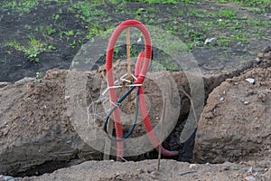 Ribbed red plastic pipes containing electric cables for lighting