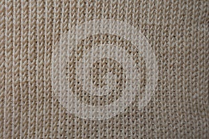 Ribbing pattern on beige knitted fabric