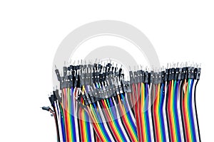 Ribbon cable or multi-wire planar cable on white background. Flat ribbon cable with pin connectors. Multi-colored ribbon computer