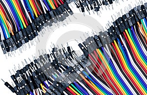 Ribbon cable or multi-wire planar cable on white background. Flat ribbon cable with pin connectors. Multi-colored ribbon computer