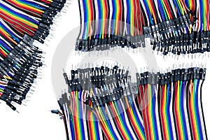 Ribbon cable or multi-wire planar cable on white background. Flat ribbon cable with pin connectors. Multi-colored ribbon computer photo