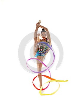 Ribbon exercise. One young beautiful female rhythmic gymnast posing isolated over white studio background