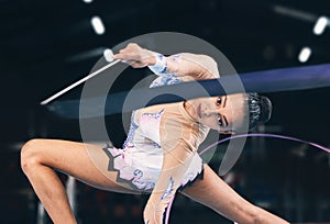 Ribbon gymnastics, woman and portrait in performance, dance training and sports competition. Female, rhythmic movement