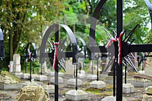 Ribbon with national colours of Poland tied up to the old cross on the cemetery. Rebelion uprising concept. photo