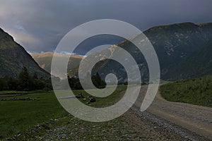 ribbon of the road among the slopes of the mountains on the expanses of Altai on a summer day