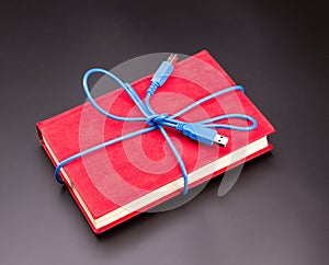 Ribbon from the usb cable on book as a present