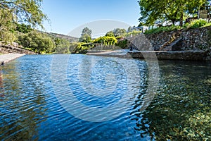 Water from the stream beach of PoÃÂ§o de Corga with reflected shadows, Castanheira de PÃÂªra PORTUGAL photo