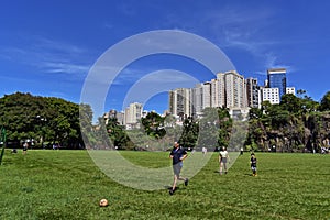 People enjoying sunny day on public park in Ribeirao Preto, Brazil