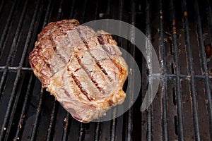 Ribeye Steak grilling on a Barbecue